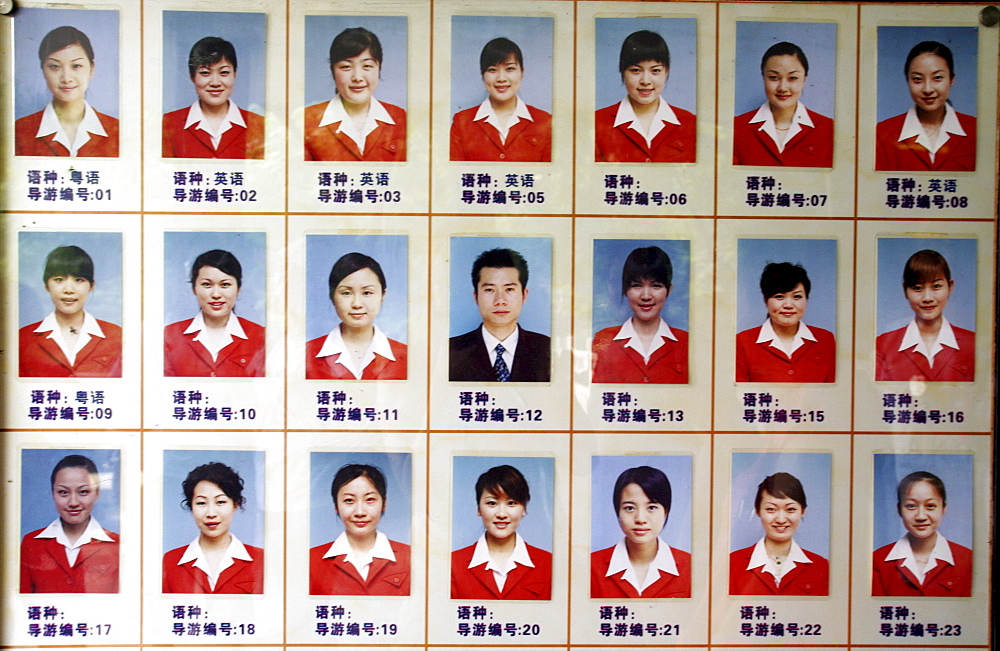 A sign shows the photos of tour guides at a tourist site in Guilin, China.