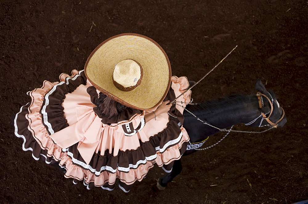 An escaramuza from Anahuac of Tecamac team rides her horse in a rodeo competition in Mexico City, May 10, 2008. Escaramuzas are similar to US rodeos, where female competitors called "Amazonas" wear long skirts, and ride side saddle. Male rodeo competitors are "Charros," from which comes the word "Charreria." Charreria is Mexico's national sport.