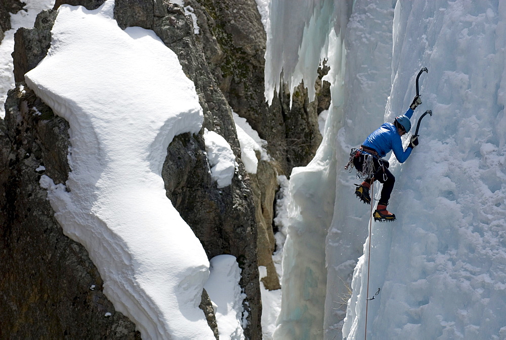 A woman ice climbing in the Ouray Ice Park, Ouray, Colorado.