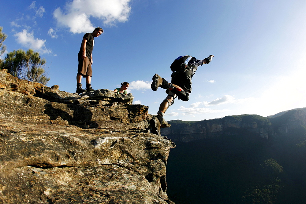 A BASE jumper performs a front flip off a cliff in the Blue Mountains, New South Wales, Australia.