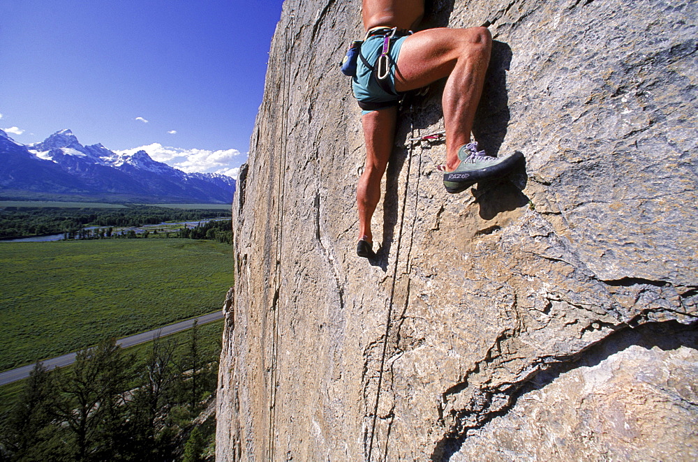 Climbing on Blacktail Butte with a view of the Tetons to the west.