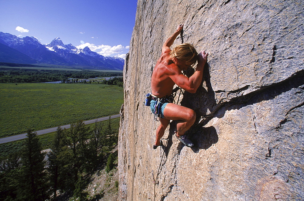 Climbing on Blacktail Butte with a view of the Tetons to the west.