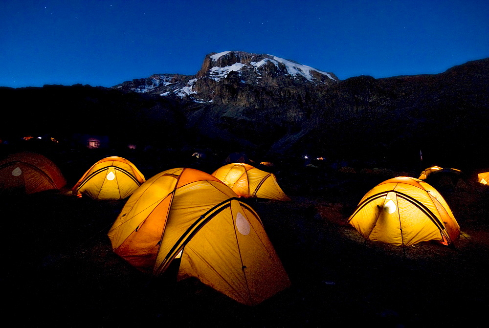 Tents illuminate the night 2,000 ft. below the summit of Mt. Kilimanjaro.