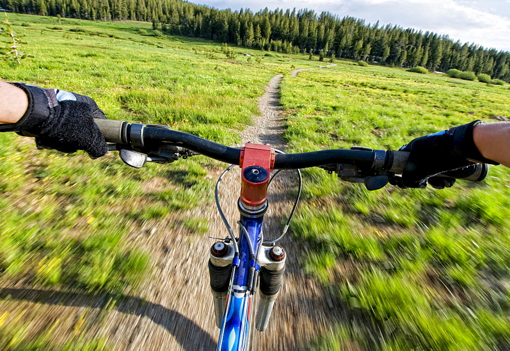 A young woman catches a quick mountain bike ride before the sun goes down in Lake Tahoe, Nevada.