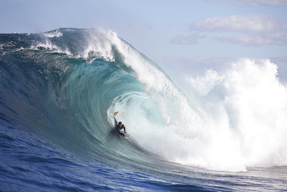 A surfer bodyboarding a dangerous wave at Shipstern bluff, in Tasmania.