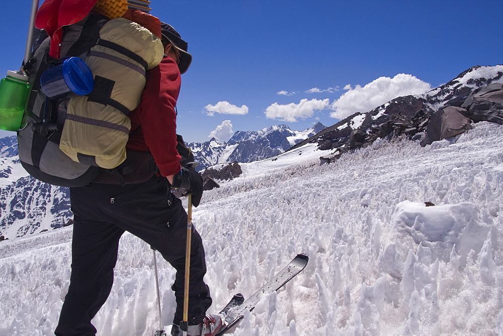 A man ski mountaineering through penitentes on Volcan San Jose in the Andes mountains of Chile