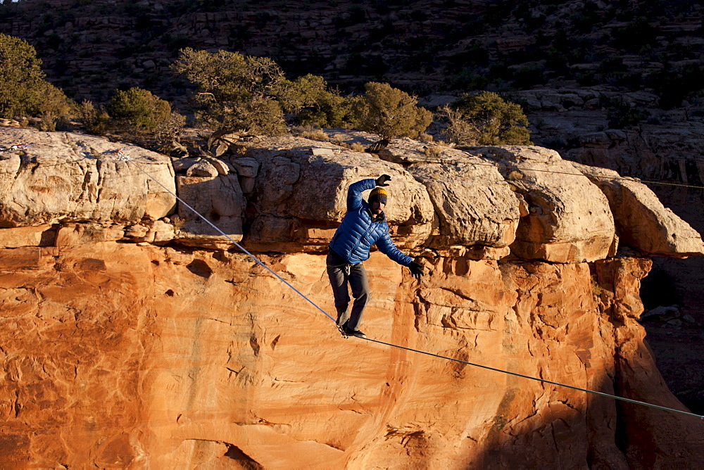 A highliner walks across a long slackline, Moab, Utah.