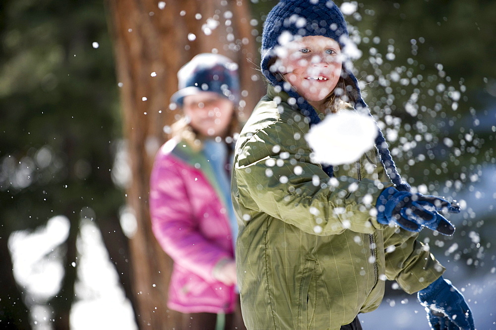 A boy and girl enjoy a snowball fight in Lake Tahoe, California.