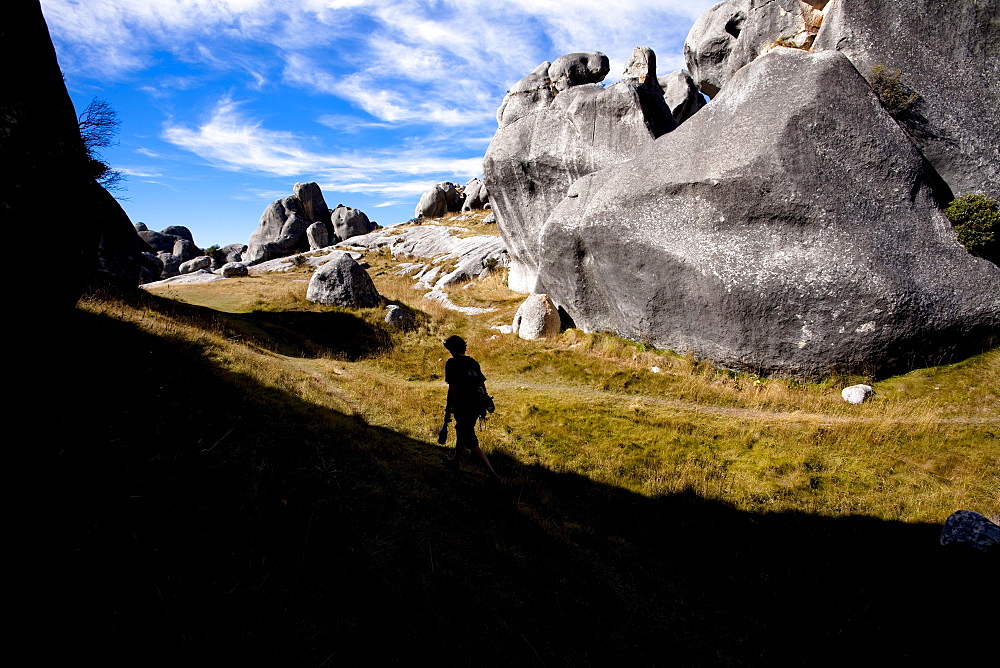 A climber walks back to his rental car on April 10, 2007 from a day of bouldering in Castle Hill, Canterbury, New Zealand.