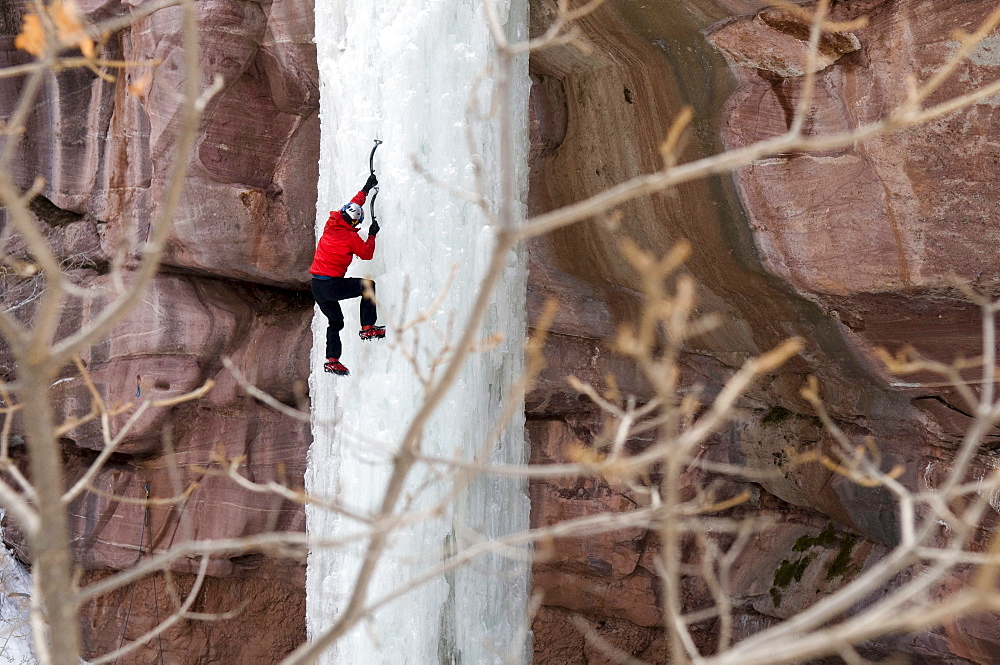 Man climbing ice pillar without a rope, Redstone, Colorado.