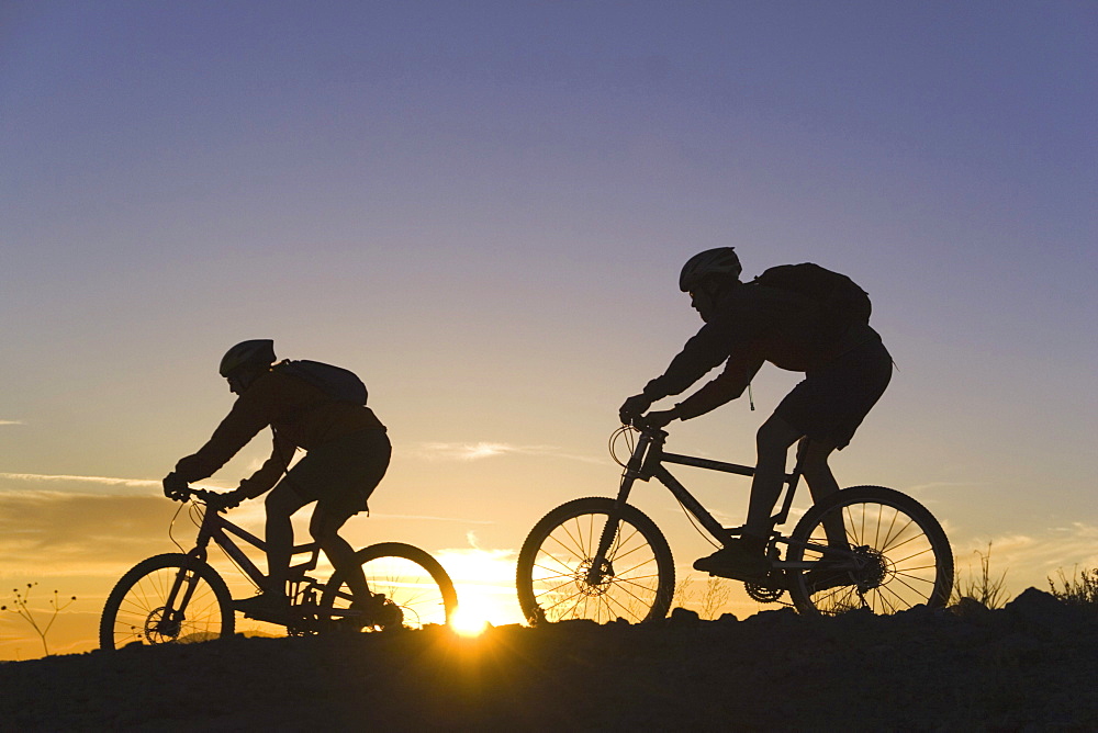 Mountain biking at sunset in California.