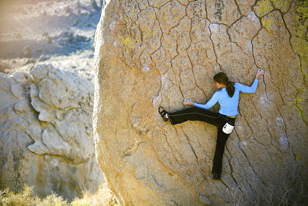 Woman bouldering on an overhang