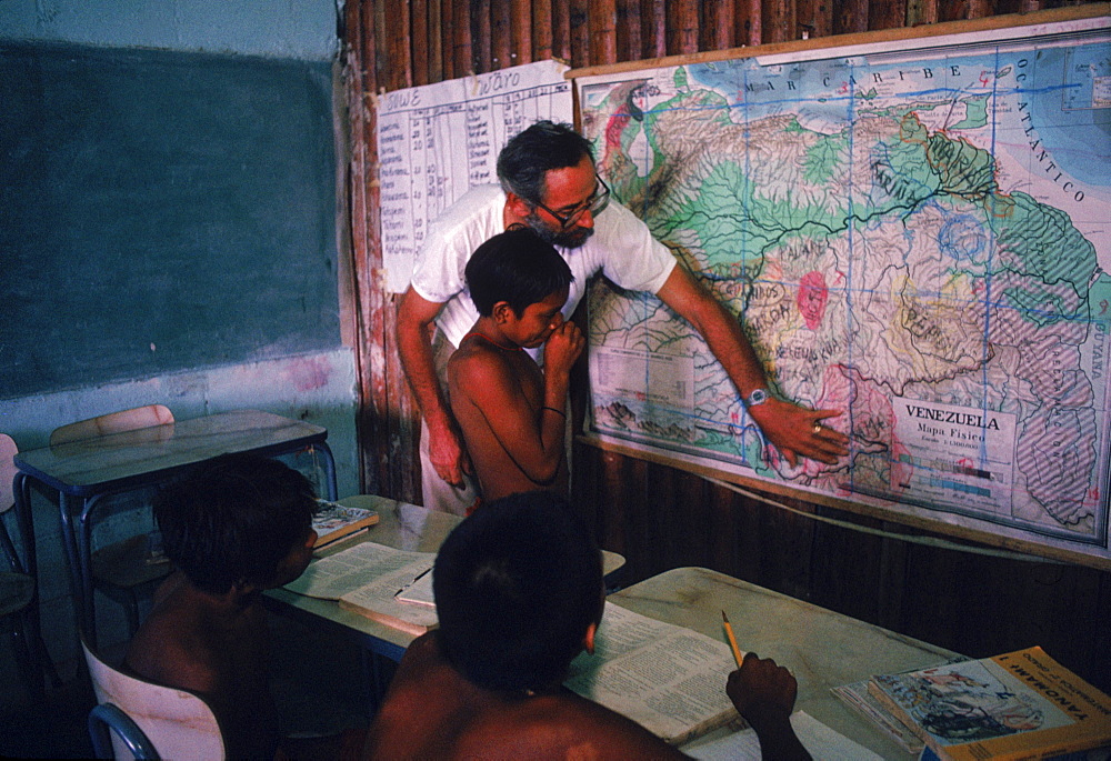 Father Bortoli teaching Yanomami Indian children at the Catholic mission school at Mavaca on the Upper Orinoco River. In the Amazonian Forest in southern Venezuela.