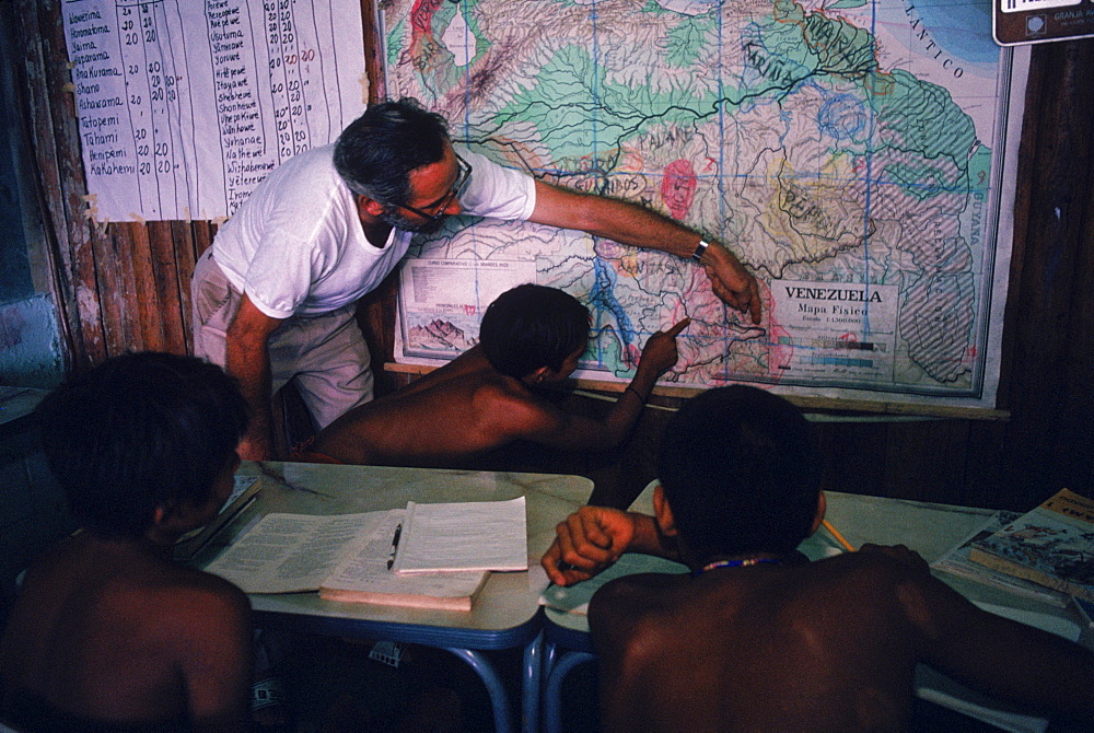 Father Bortoli teaching Yanomami Indian children at the Catholic mission school at Mavaca on the Upper Orinoco River. In the Amazonian Forest in southern Venezuela.