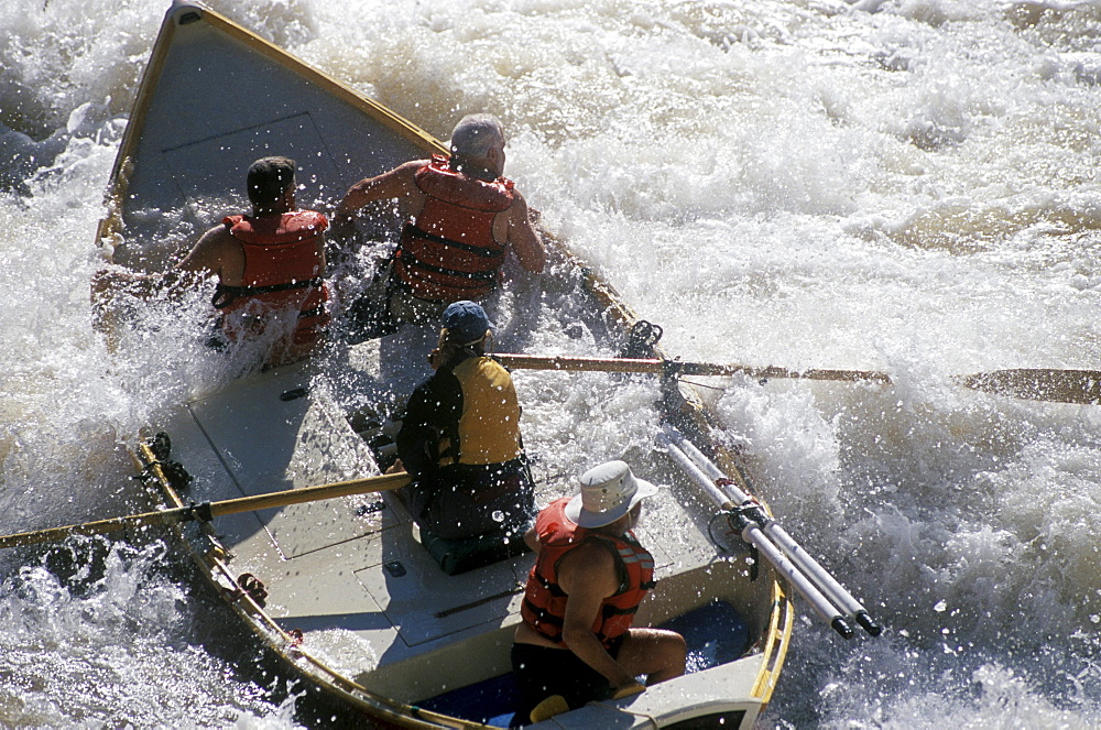 A wooden dory is tossed in the whitewater of 24-Mile Rapid on the Colorado River in Grand Canyon National Park, Arizona.