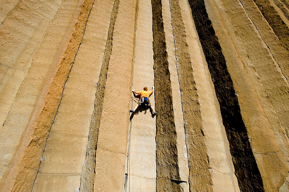 A mid adult man rock climbing at Trout Creek, Oregon.