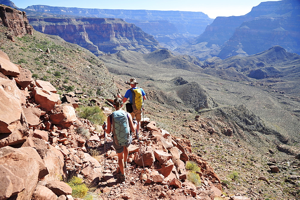 Hikers descend into Surprise Valley to access the lower canyon through a break in the 400-foot-tall Redwall on the Thunder River Trail in the Grand Canyon outside of Fredonia, Arizona November 2011.  The 21.4-mile loop starts at the Bill Hall trailhead on the North Rim and descends 2000-feet in 2.5-miles through Coconino Sandstone to the level Esplanada then descends further into the lower canyon to access Thunder River, Tapeats Creek and Deer Creek.