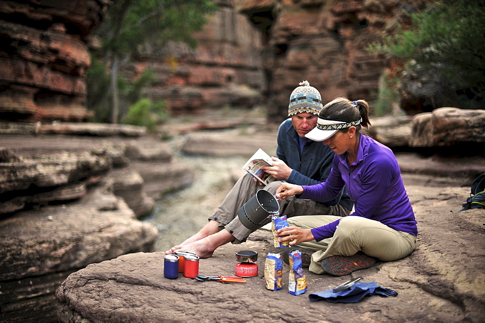 Hikers cook dinner along Deer Creek Narrows in the Grand Canyon outside of Fredonia, Arizona November 2011.  The 21.4-mile loop starts at the Bill Hall trailhead on the North Rim and descends 2000-feet in 2.5-miles through Coconino Sandstone to the level Esplanada then descends further into the lower canyon through a break in the 400-foot-tall Redwall to access Surprise Valley.  Hikers connect Thunder River and Tapeats Creek to a route along the Colorado River and climb out Deer Creek.