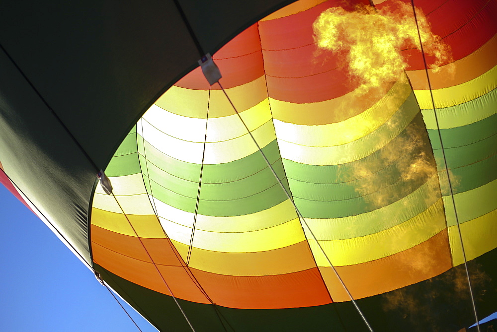 Hot air balloons lift skyward. The Albuquerque International Balloon Fiesta takes place in Albuquerque, New Mexico each year drawing in participants and spectators from across the globe. Highlights include an early morning dawn patrol, followed by mass ascencion of aircraft and an evening glow which all take place at the Balloon Fiesta Park throughout the week long event.