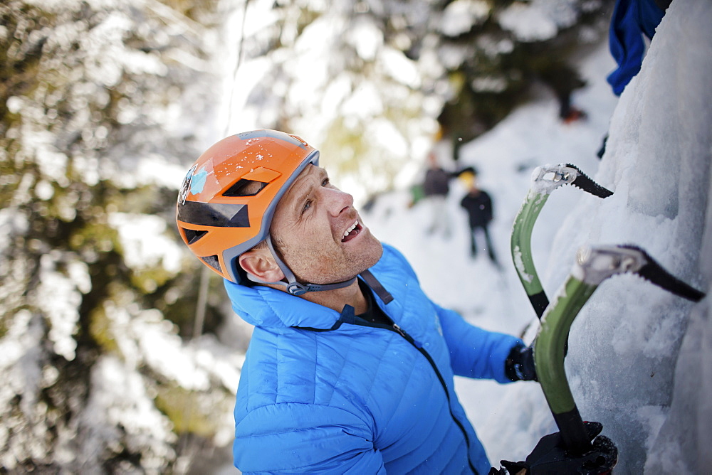 A ice climber looks for his next hold in Whistler, British Columbia, Canada, Whistler, British Columbia, Canada