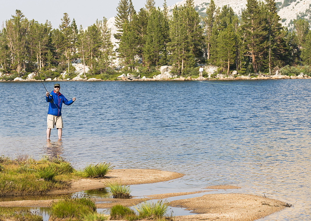 A man tries his hand at a little early morning fly fishing in the High Sierra, California