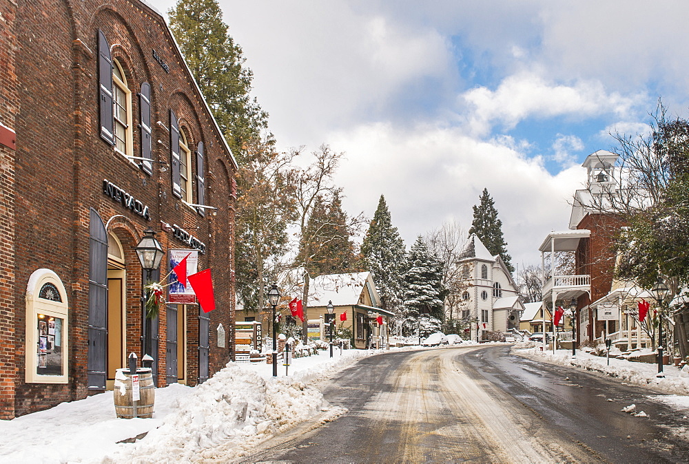 Historic Nevada City and Nevada Theater with fresh snow. The theater was built in 1865 it is the oldest continuously running theater in California, Nevada City, California, USA