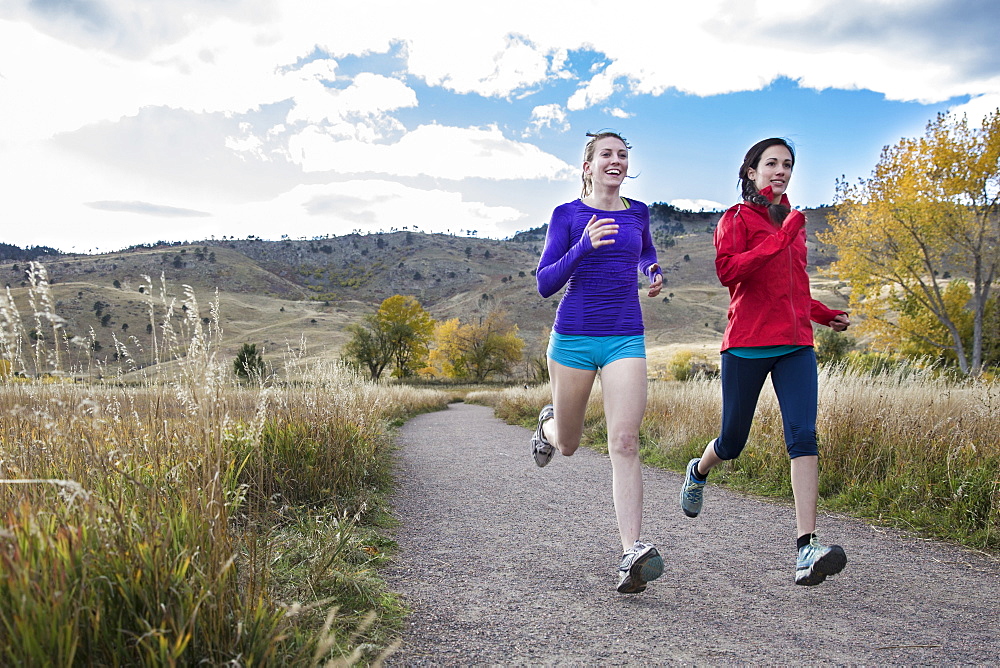 Females running outside together in the foothills of Boulder, Colorado, Boulder, Colorado, United States