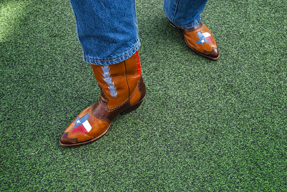 A Texan displays his pride of the lone star state with his custom cowboy boots, Dallas, Texas, USA