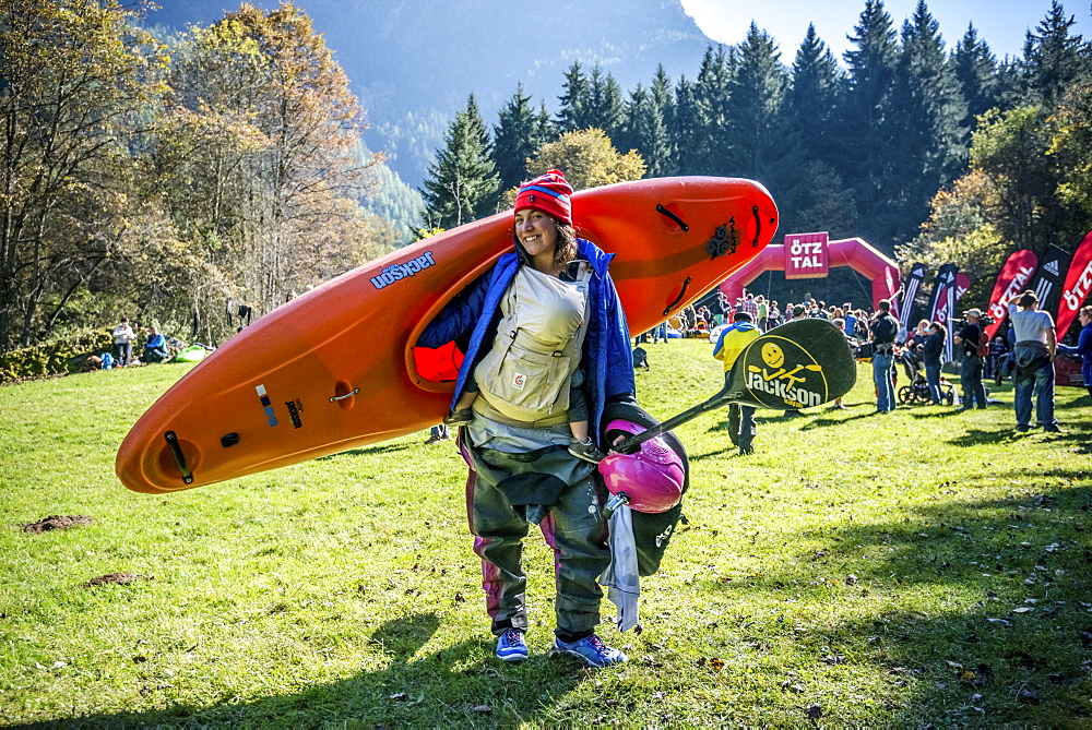 Kayaker Emily Jackson (USA) carrying a baby and a kayak at the Adidas Sickline Extreme Kayaking World Championship 2014 in Oetz, Austria.