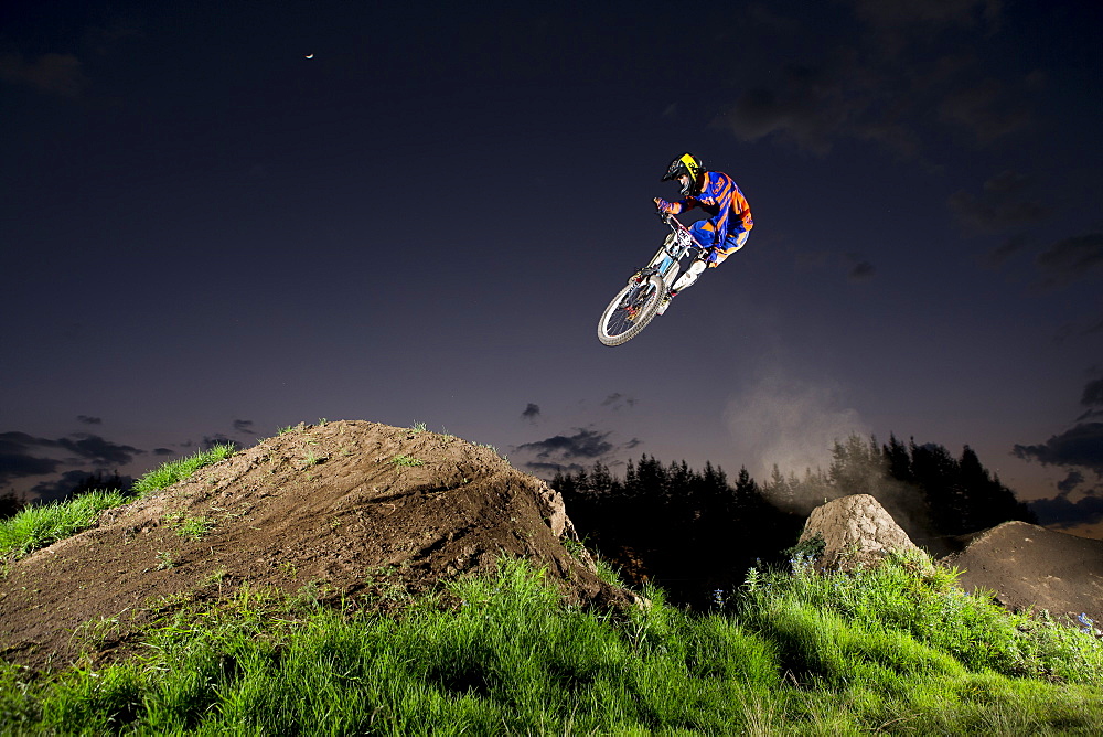 A young man jumps at the dirt track on a clear night near Toluca, Mexico