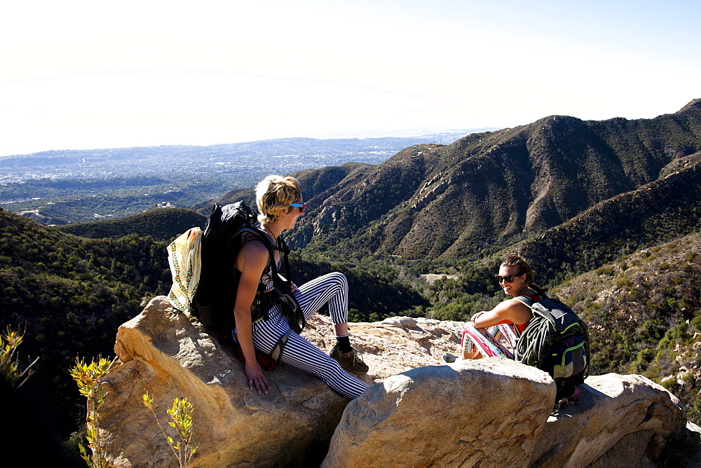 Two female climbers talk after climbing on Lower Gibraltar Rock in Santa Barbara, California