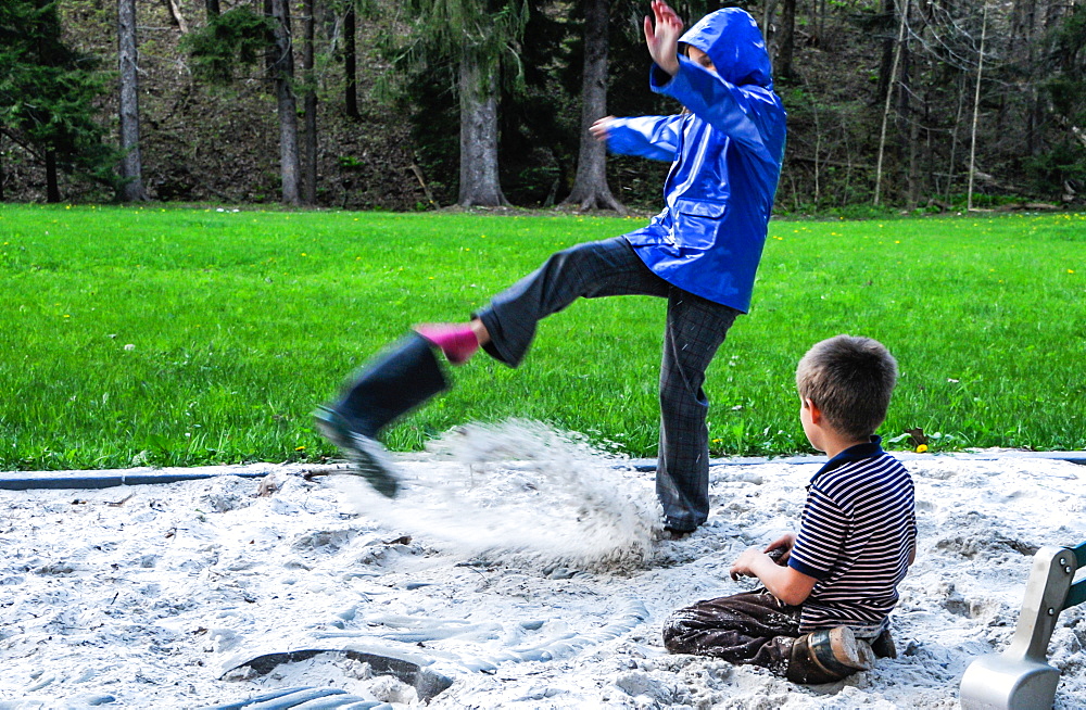 A girl kicks sand out from her boot at Laurel Hill State Park PA