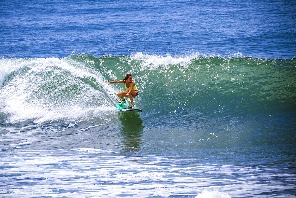 Surfer girl catches wave in high heels.