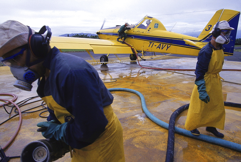 The ground crew prepares an airplane that will spray the systemic fungicide SICO on the fields.