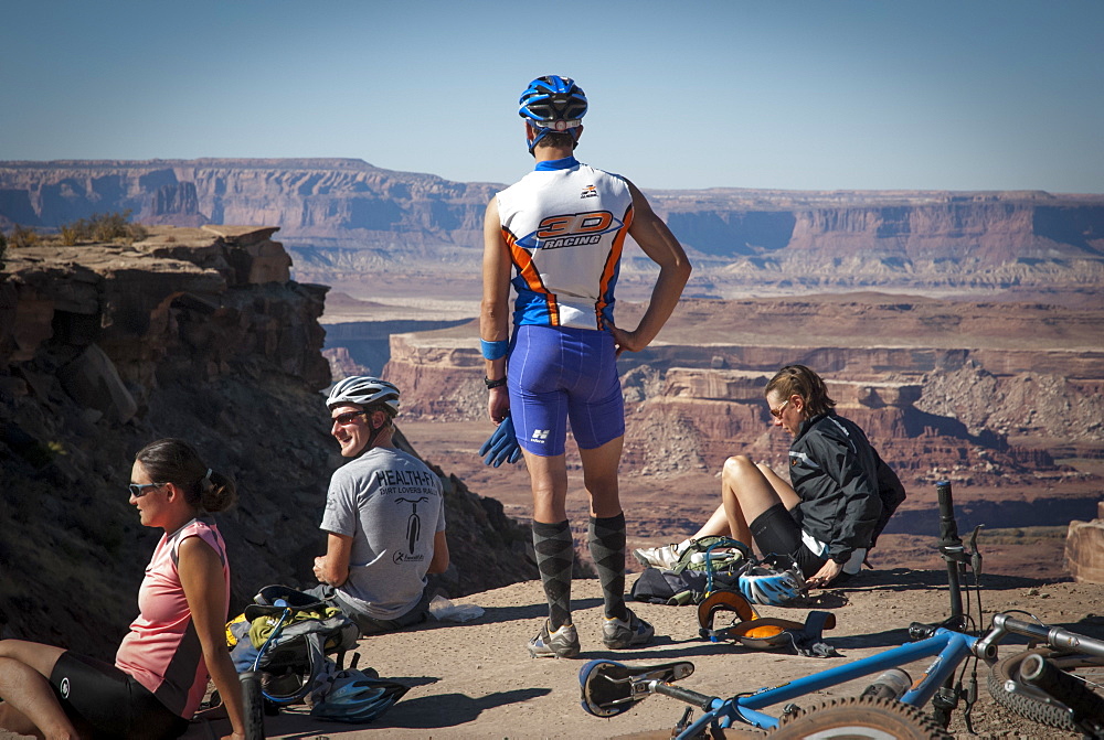 Friends explore the Utah desert in autumn with an extended mountain biking adventure on the White Rim Trail, Canyonlands National Park near Moab, Utah.