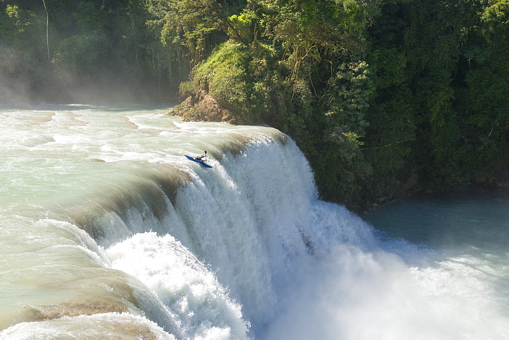 One kayaker dropping a 50 ft waterfall at Cascadas de Agua Azul, Chiapas, Mexico.