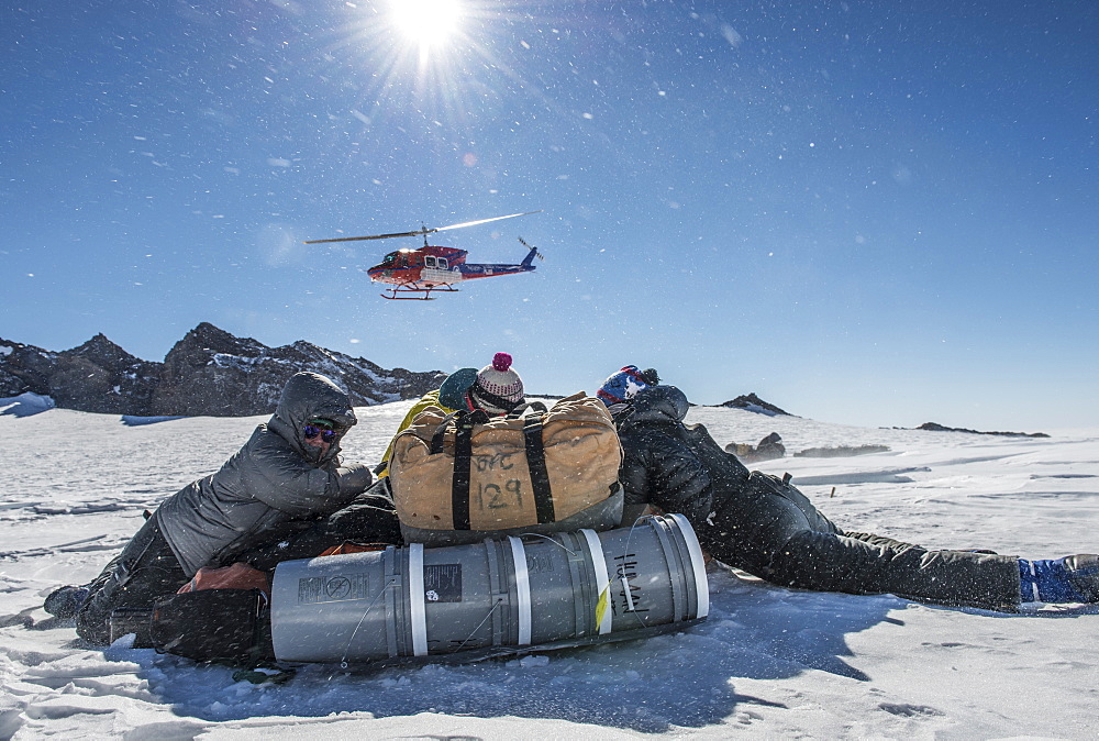 Sheltering from the rotor wash of a Bell 212 helicopter after being dropped off at 11,000ft on the slopes on Mount Erebus, Antarctica.