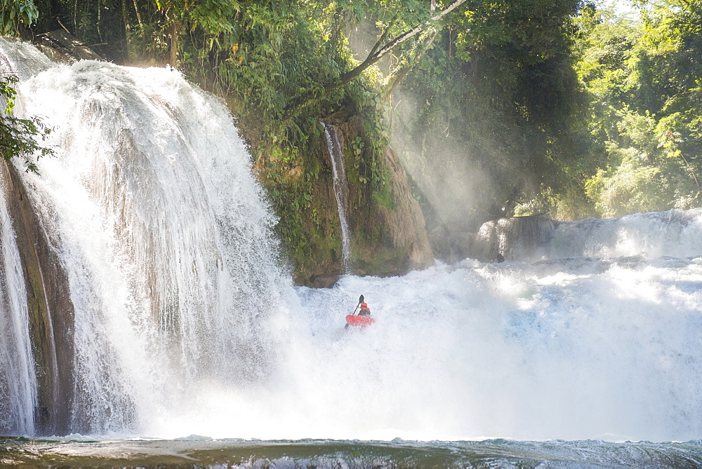 One man descending a waterfall in his kayak at Cascadas de Agua Azul, Chiapas, Mexico.