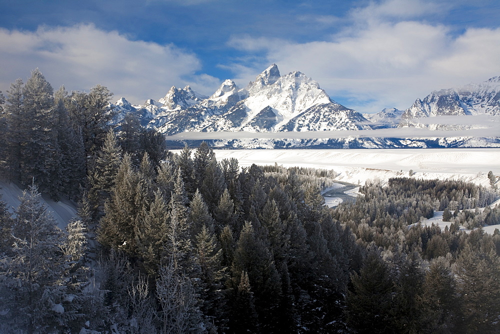 The Tetons rise above the Snake River in Grand Teton National Park, Wyoming, under fresh snow.