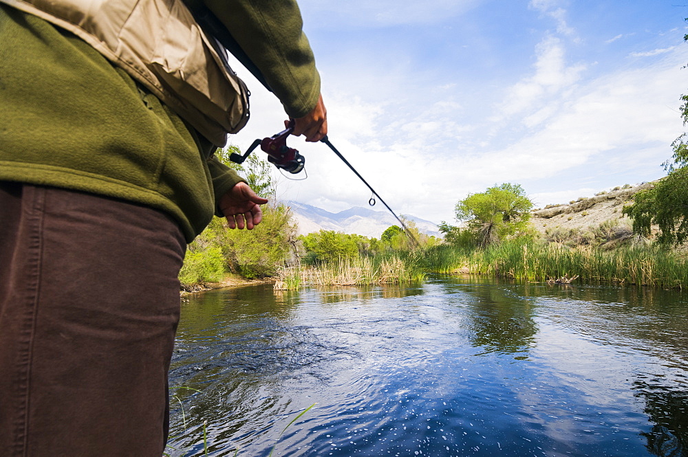 A fisherman throws his line in Owens River just below Manzanar Reward Road, Eastern Sierras, California.