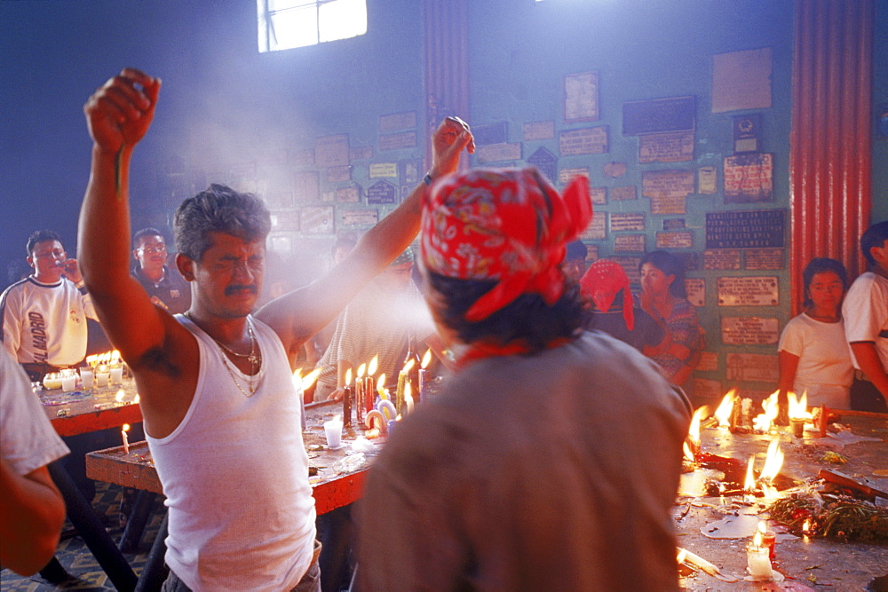 Priests douse worshipers with a spray of alcohol during a ritual blessing at a temple.