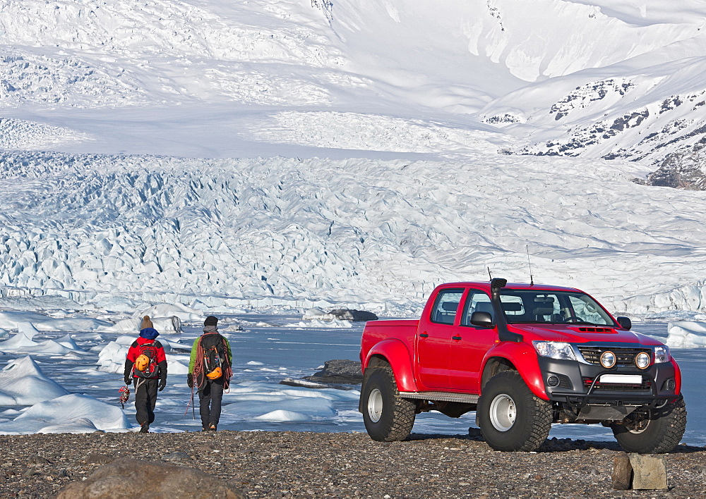 2 climbers hiking of from customised SUV / Icelandic superjeep