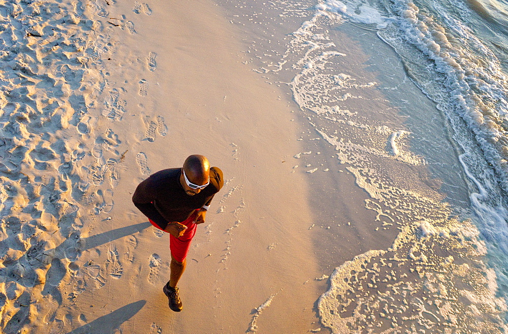 Man running on the beach, from above