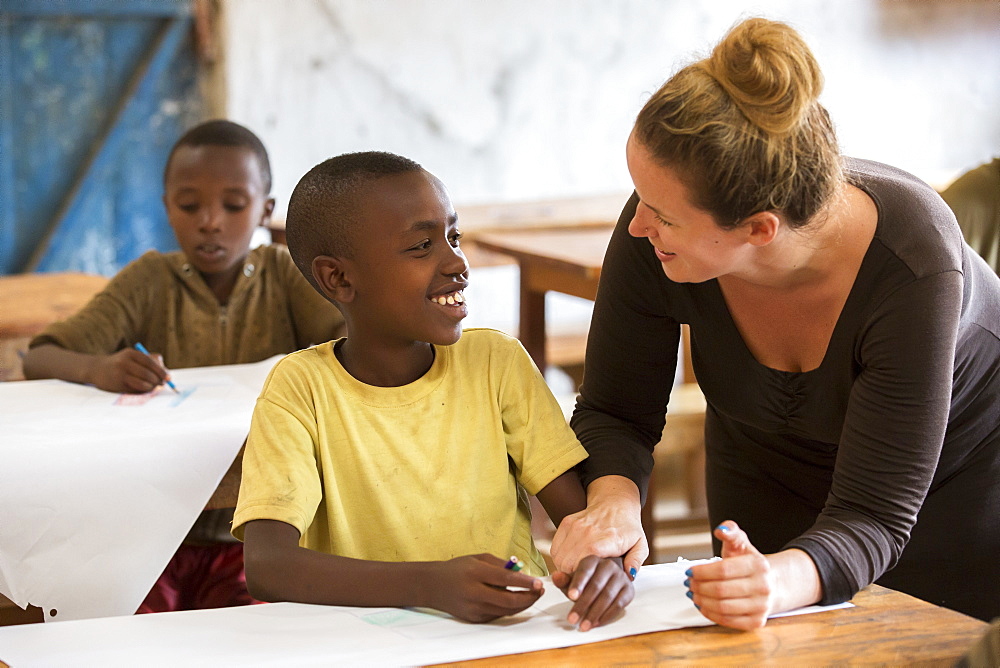 A visiting teacher interacts with a student at the Kiziba Refugee Camp in Kibuye, Rwanda.