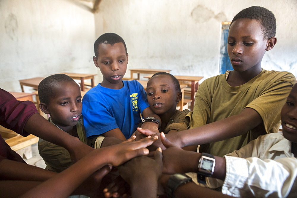 Student work on a problem solving game at the Kiziba Refugee Camp in Kibuye, Rwanda.