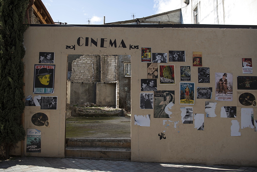 The remnants of a movie theater still donned with cinema posters sits in ruins in the old town district of Tbilisi, Republic of Georgia.