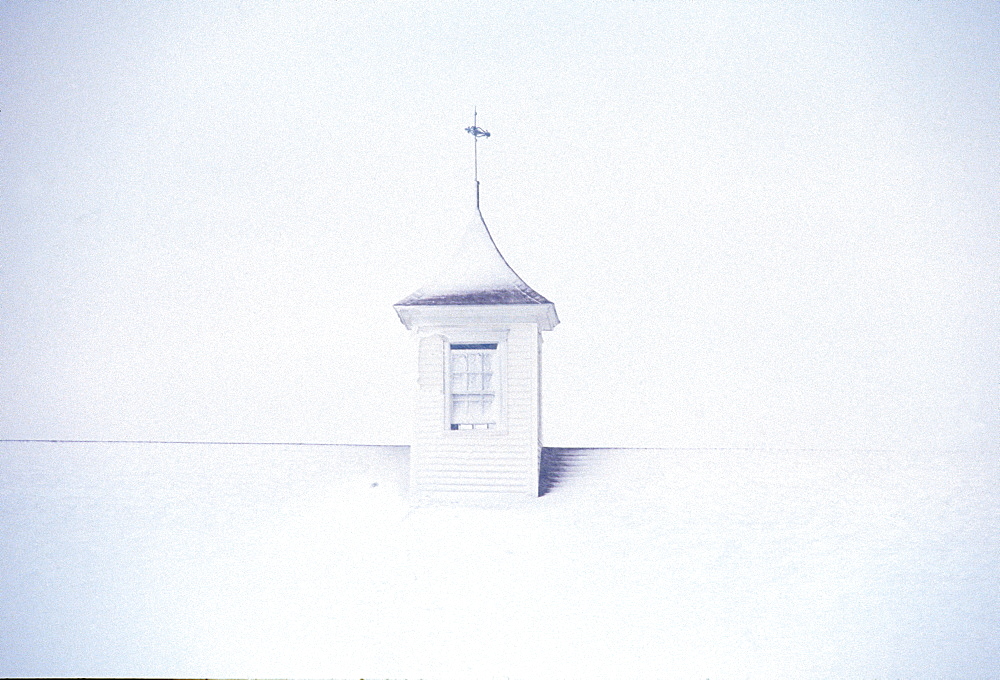 A barn cupola on a post and beam barn in Pownal, ME during a winter storm, United States of America