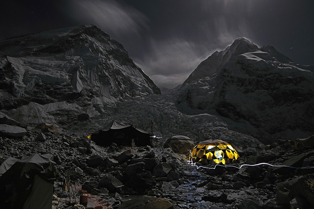 Night scene of a dining tent at the Everest Base Camp. The summit of Everest is blocked by part of the ridge that extends out on the left, while Nupste can be seen on the right of the picture. The infamous Khumbu ice fall can be seen as the rubble that pours out in the middle of the picture, Nepal