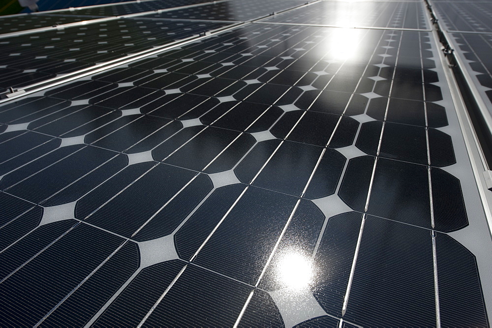 Closeup of a photovoltaic panel with the sun reflecting, United States of America