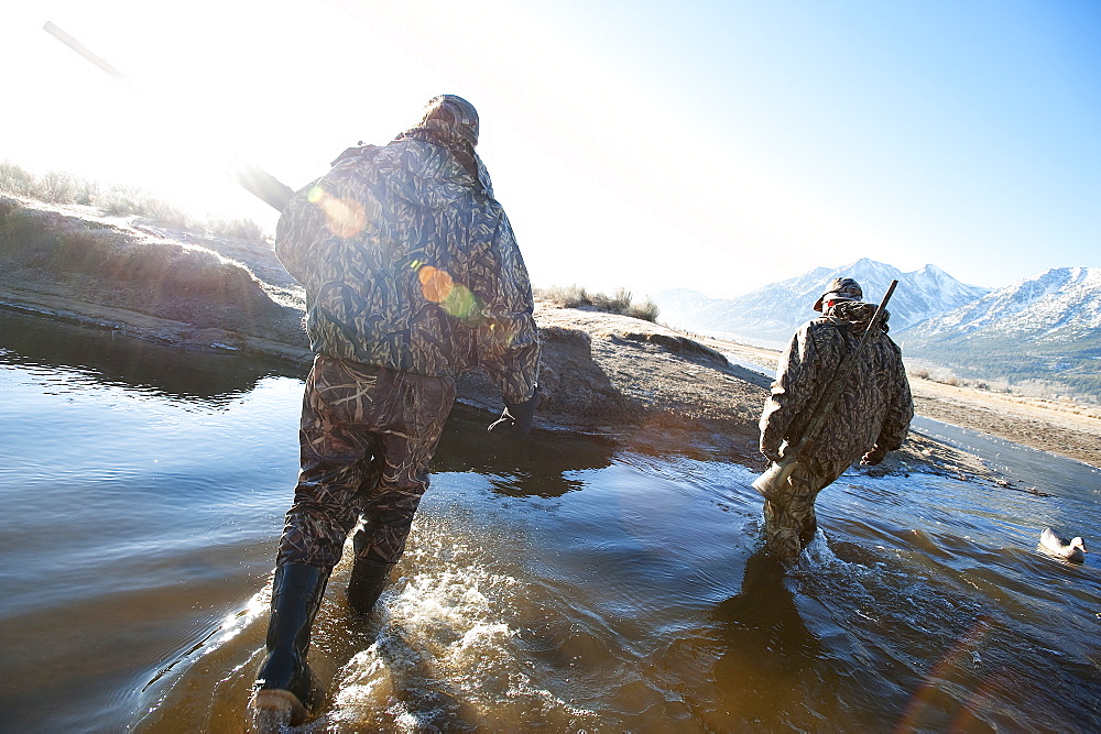 Brad Jackson and Corey Funk hunt ducks with their dog Grizzly in Carson City, NV, United States of America